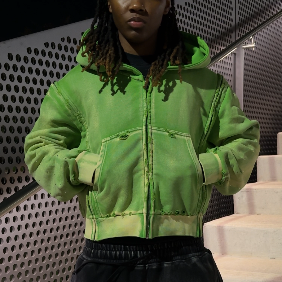 Model wearing the green interchangeable zip-up hoodie
